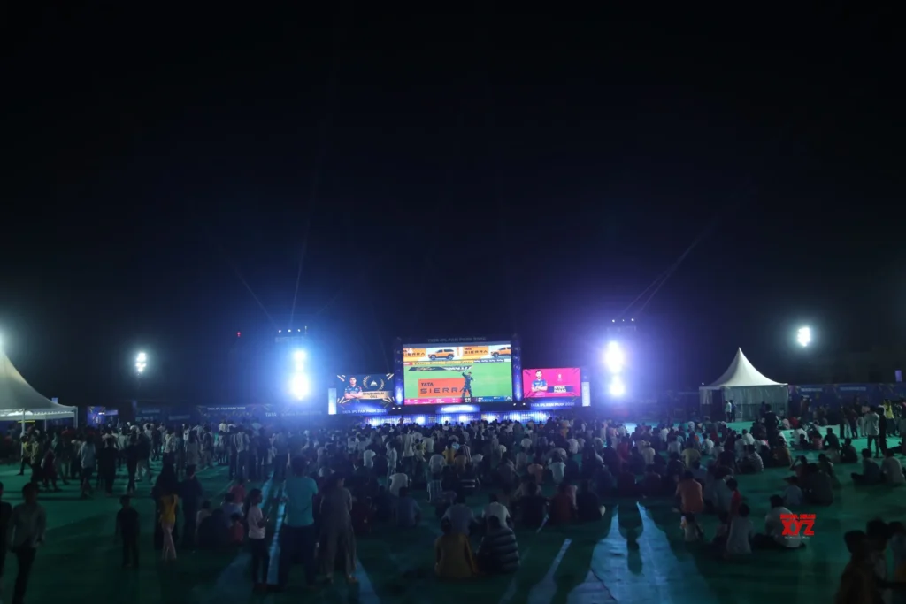 Huge crowd watching IPL match on giant screen at TATA IPL Fan Park 2026 in a small Indian city