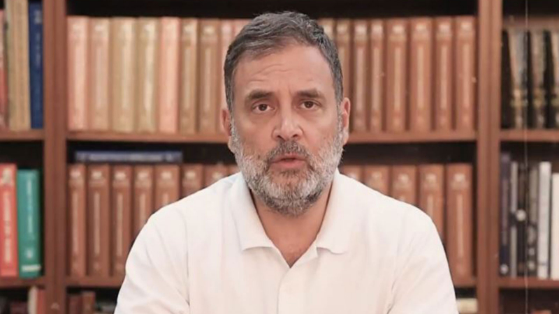 Rahul Gandhi addressing the media in New Delhi while students holding exam papers and admit cards stand in the background, highlighting concerns over exam transparency and paper leak controversies.