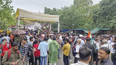  A crowd of students holding placards demanding accountability, representing nationwide anger over examination leaks.